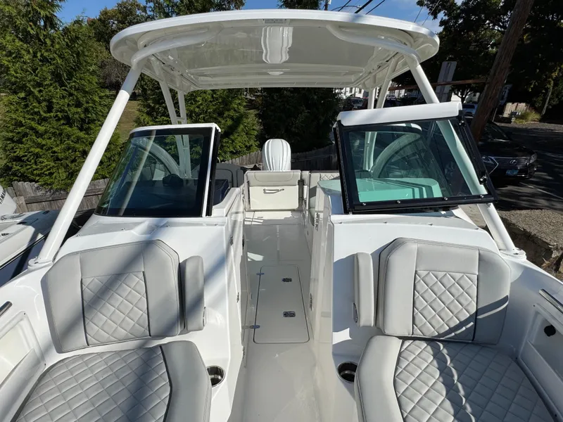 Slide: The Image of 2025 Pursuit DC 246 Dual Console boat with spacious seating and modern design. - 9