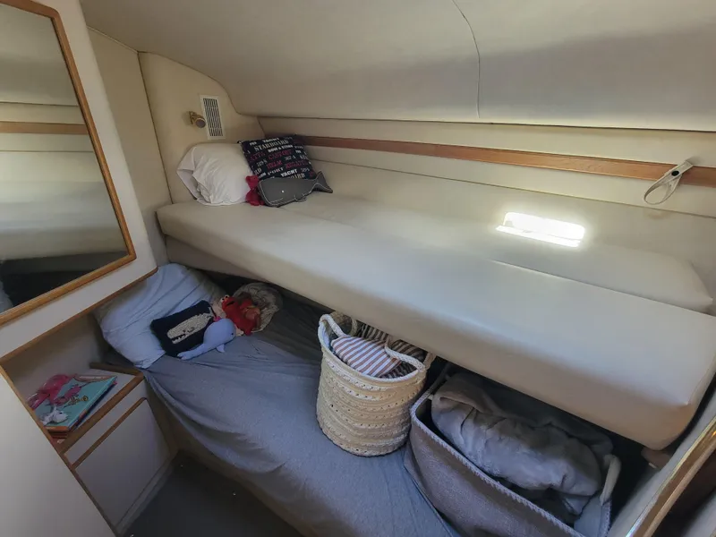 Slide: The Image of 1997 Sea Ray 400 Express Cruiser cabin with bunk beds and storage baskets. - 11