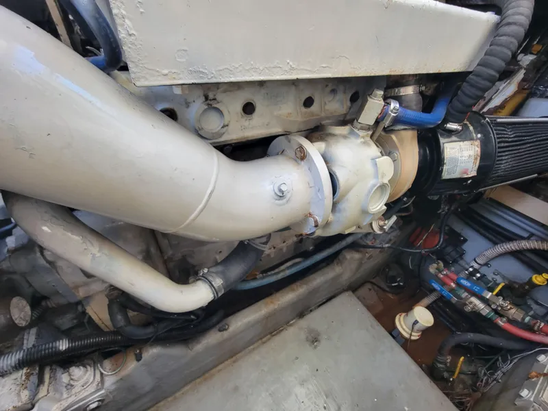 Slide: The Image of Engine compartment of a 1997 Sea Ray 400 Express Cruiser, showcasing mechanical components and piping. - 18