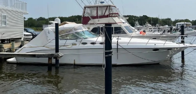 Slide: The Image of 1997 Sea Ray 400 Express Cruiser docked at marina, side view. - 2