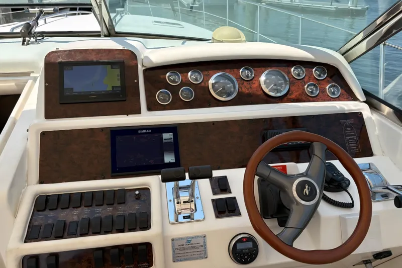 Slide: The Image of 1997 Sea Ray 400 Express Cruiser dashboard with navigation screens and gauges. - 9