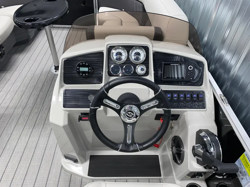 Slide: The Image of 2025 Sylvan Mirage 8520 Party Fish boat dashboard with steering wheel and controls. - 12