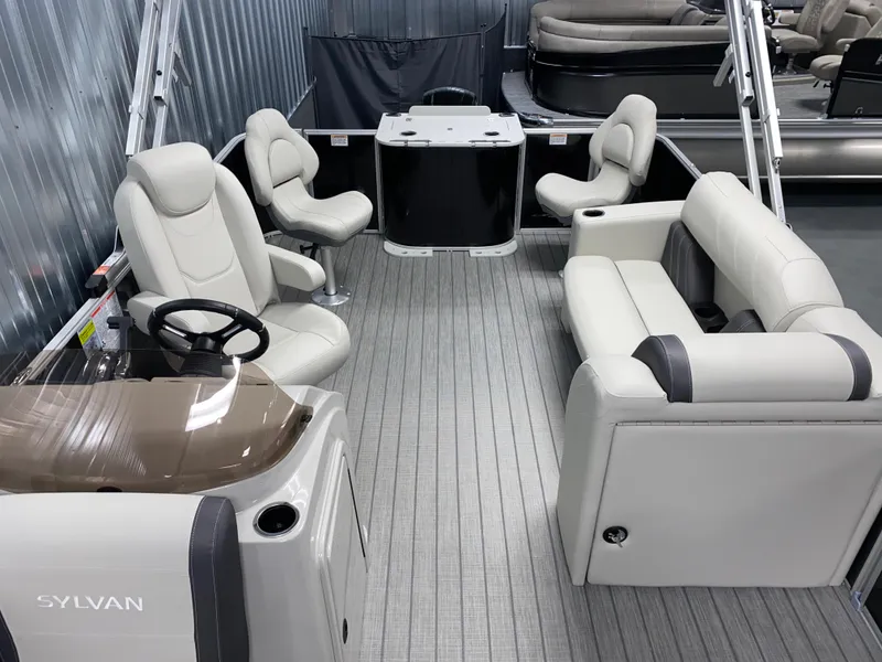 Slide: The Image of 2025 Sylvan Mirage 8520 Party Fish boat interior with plush seating and steering console. - 13