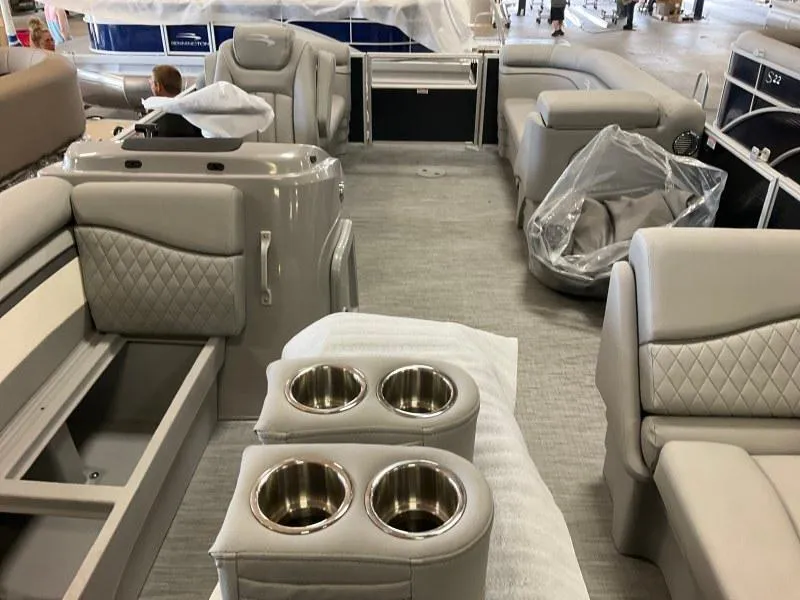 Slide: The Image of 2023 Bennington 21SSR pontoon boat interior with plush seating and cup holders. - 12