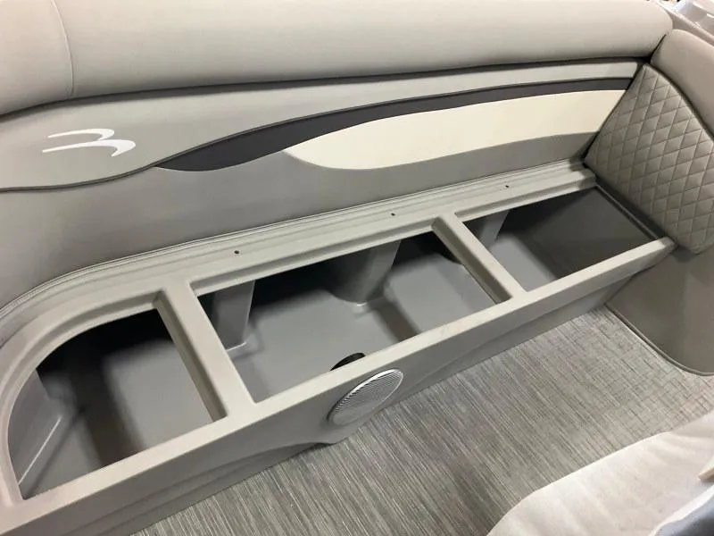 Slide: The Image of 2023 Bennington 21SSR boat interior storage compartment with sleek design and quilted upholstery. - 13