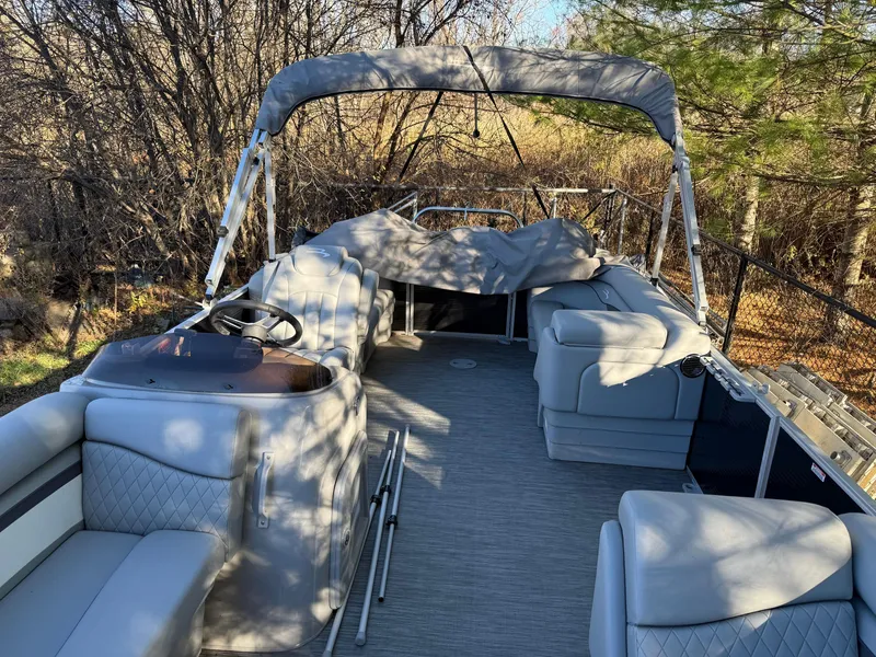 Slide: The Image of 2023 Bennington 21SSR pontoon boat with gray seating and canopy in wooded area. - 18
