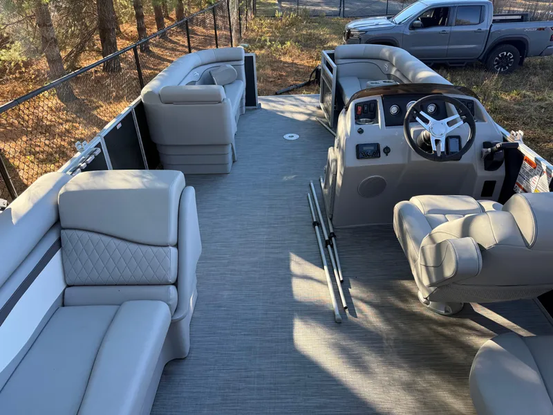 Slide: The Image of 2023 Bennington 21SSR pontoon boat interior with plush seating and modern helm. - 19