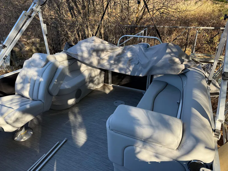 Slide: The Image of 2023 Bennington 21SSR pontoon boat interior with gray seating and cover. - 20