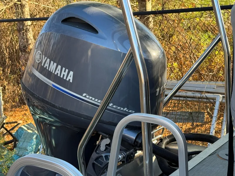 Slide: The Image of Yamaha outboard motor on 2023 Bennington 21SSR pontoon boat, outdoor setting. - 21
