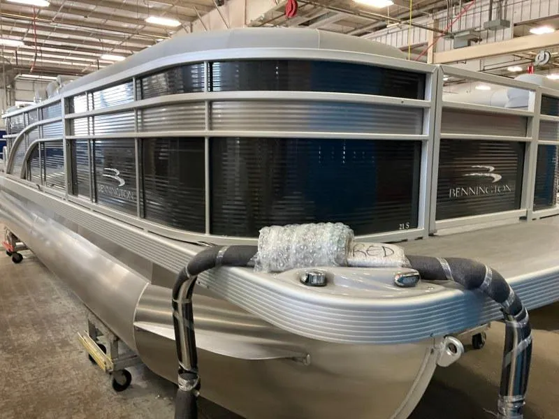 Slide: The Image of 2023 Bennington 21SSR pontoon boat in a warehouse setting. - 5