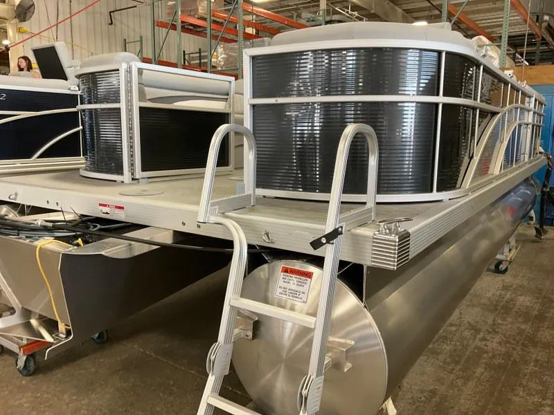Slide: The Image of 2023 Bennington 21SSR pontoon boat in a warehouse setting. - 6