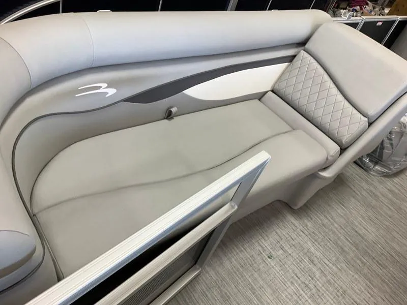 Slide: The Image of 2023 Bennington 21SSR boat interior with gray cushioned seating and quilted design. - 8
