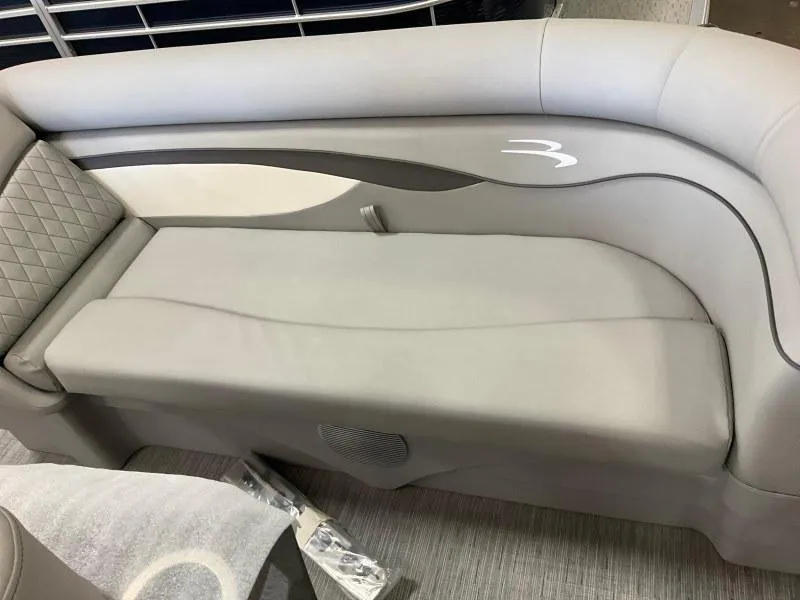 Slide: The Image of 2023 Bennington 21SSR boat interior with gray cushioned seating and stylish design. - 9