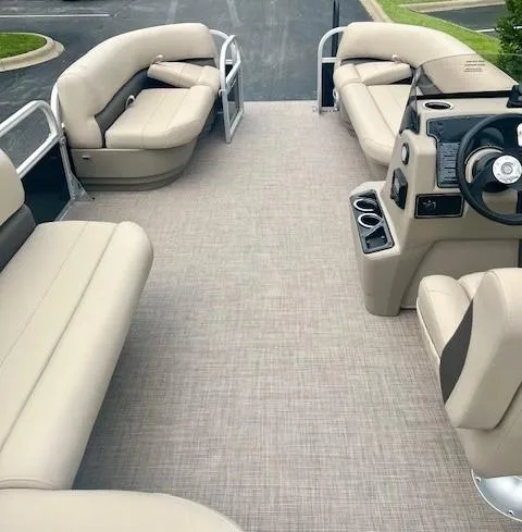 Slide: The Image of 2025 Sun Tracker Party Barge 16 DLX interior with beige seating and modern console. - 3