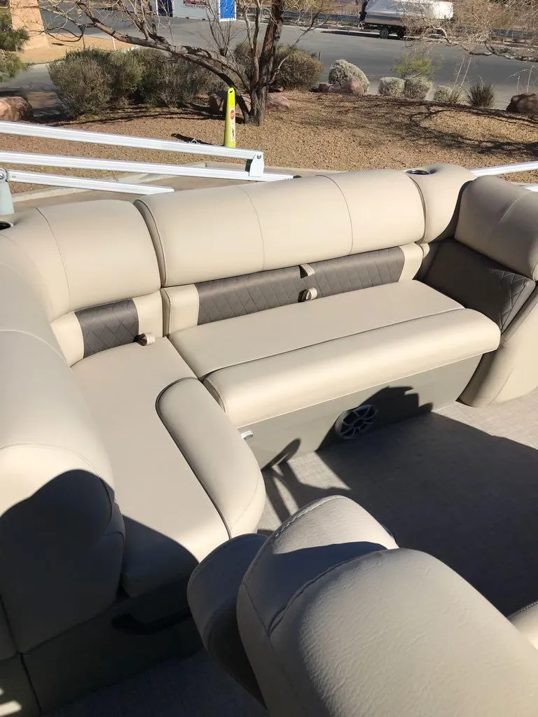 Slide: The Image of 2025 Sun Tracker Fishin' Barge 20 DLX with beige seating, outdoor view. - 14