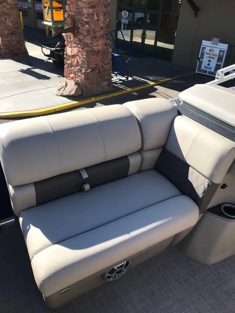 Slide: The Image of 2025 Sun Tracker Fishin' Barge 20 DLX boat seating, beige upholstery, outdoor setting. - 17