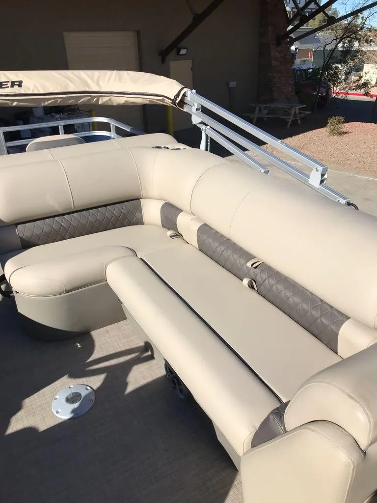 Slide: The Image of 2025 Sun Tracker Fishin' Barge 20 DLX, beige seating, outdoor setting. - 6