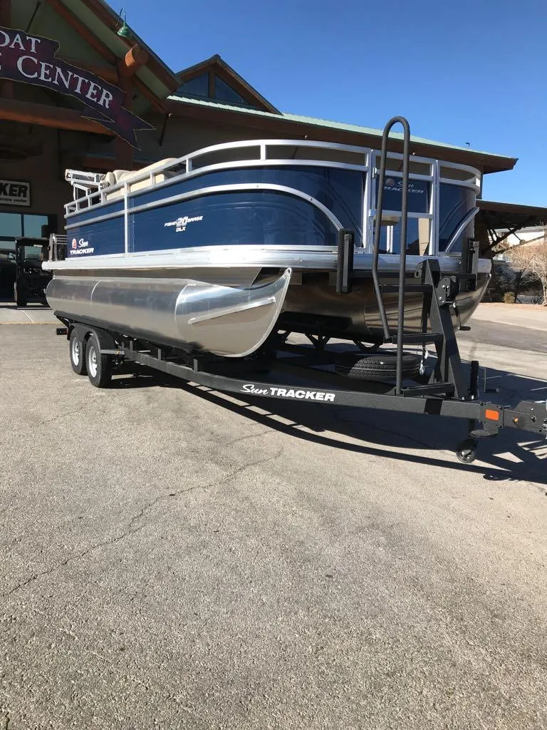 Slide: The Image of 2025 Sun Tracker Fishin' Barge 20 DLX on trailer at boat center. - 8