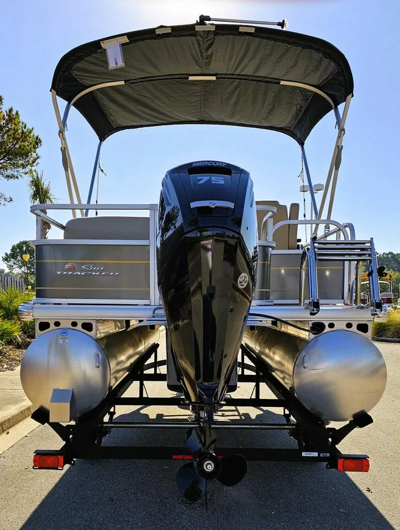 Slide: The Image of 2025 Sun Tracker Party Barge 18 DLX pontoon boat with canopy and powerful outboard motor. - 3