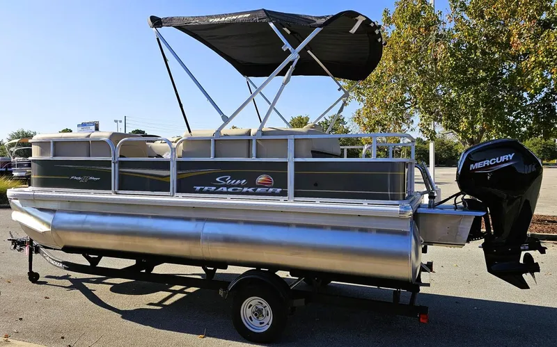Slide: The Image of 2025 Sun Tracker Party Barge 18 DLX pontoon boat with canopy and Mercury outboard motor. - 7