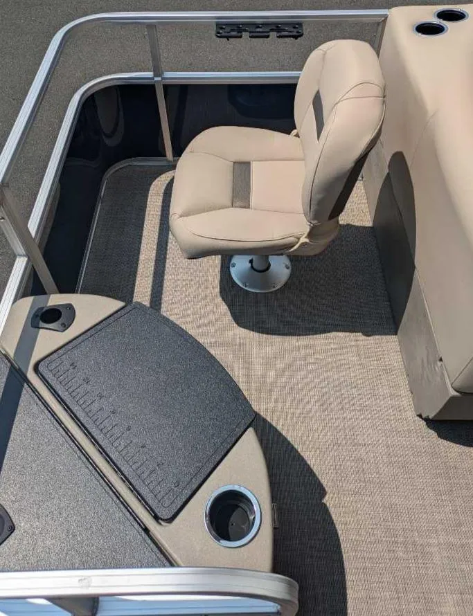 Slide: The Image of 2025 Sun Tracker Bass Buggy 18 DLX interior with beige seating and fishing station. - 10