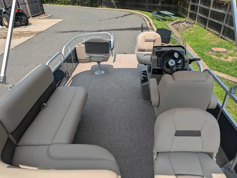 Slide: The Image of 2025 Sun Tracker Bass Buggy 18 DLX pontoon boat interior with seating and steering console. - 3