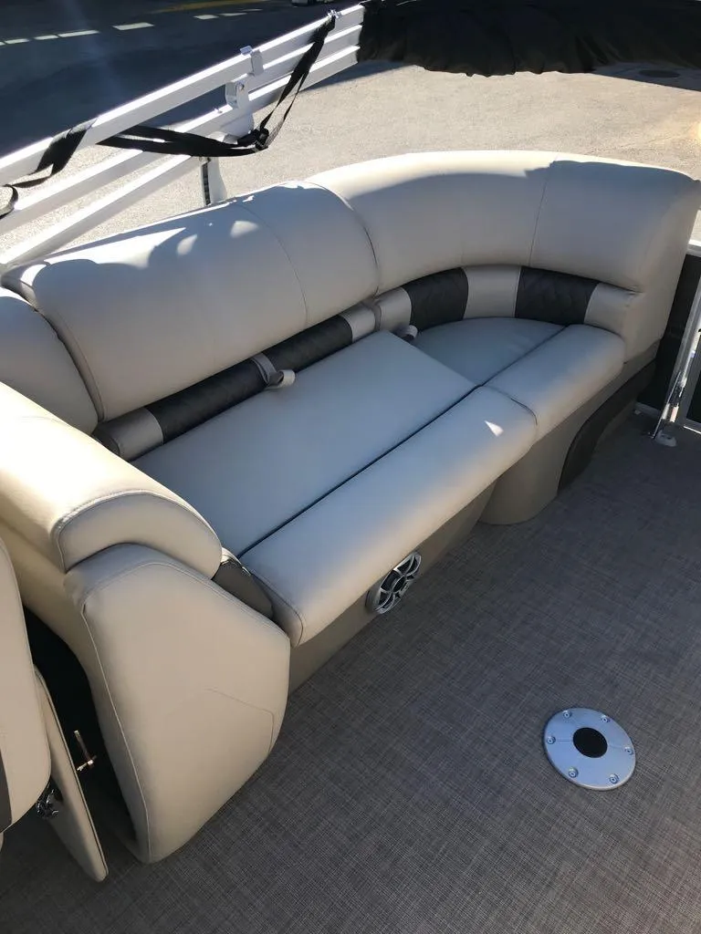 Slide: The Image of 2025 Sun Tracker Party Barge 22 DLX interior seating with plush, beige upholstery. - 12