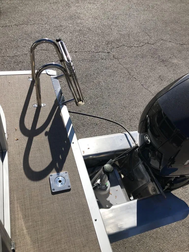 Slide: The Image of Sun Tracker Party Barge 22 DLX 2025 boat with motor and ladder detail. - 13