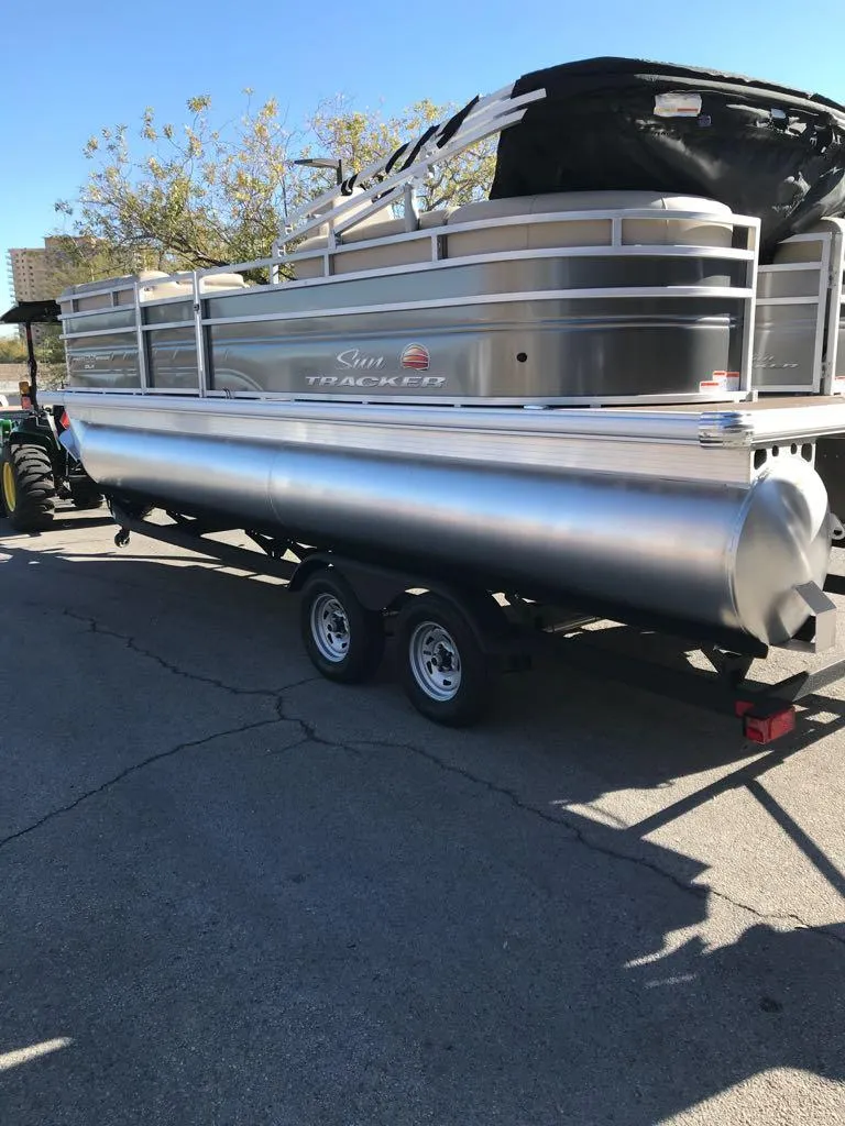 Slide: The Image of 2025 Sun Tracker Party Barge 22 DLX pontoon boat on trailer. - 4