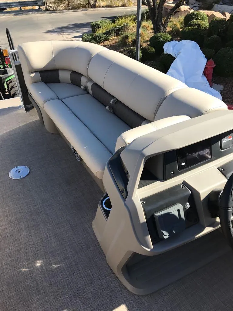 Slide: The Image of 2025 Sun Tracker Party Barge 22 DLX interior with beige seating and control panel. - 6