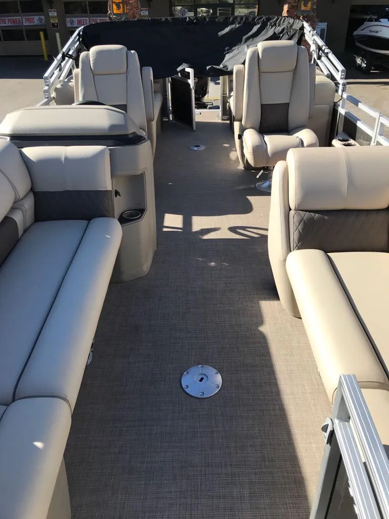 Slide: The Image of 2025 Sun Tracker Party Barge 22 DLX interior with beige seating and spacious layout. - 8