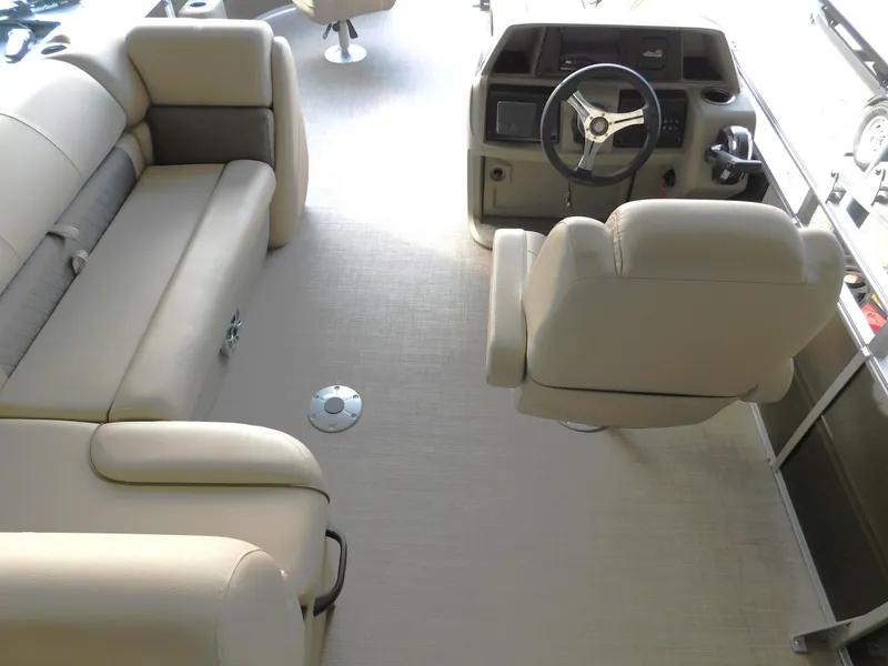 Slide: The Image of 2025 Sun Tracker SportFish 20 DLX interior with beige seating and steering console. - 10