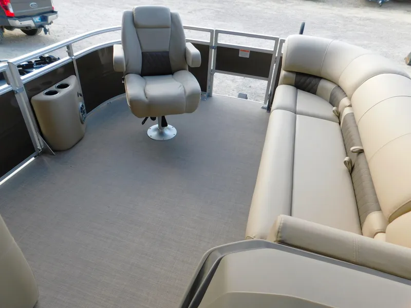 Slide: The Image of 2025 Sun Tracker SportFish 20 DLX interior with beige seating and captain's chair. - 11