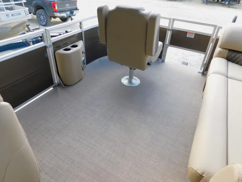 Slide: The Image of 2025 Sun Tracker SportFish 20 DLX interior with beige seating and spacious deck. - 13