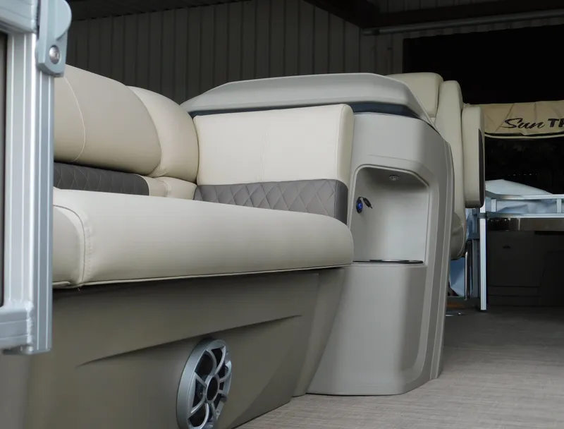 Slide: The Image of 2025 Sun Tracker SportFish 20 DLX interior with beige seating and speaker detail. - 14