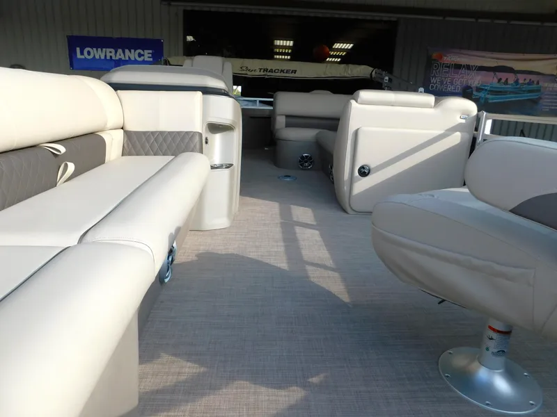 Slide: The Image of 2025 Sun Tracker SportFish 20 DLX interior with beige seating and spacious layout. - 15