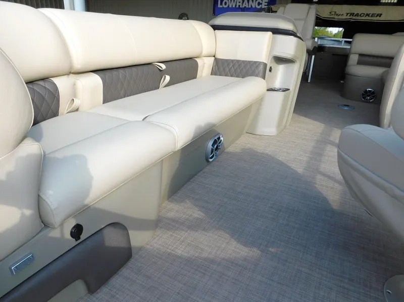 Slide: The Image of 2025 Sun Tracker SportFish 20 DLX interior with beige seating and carpeted flooring. - 17