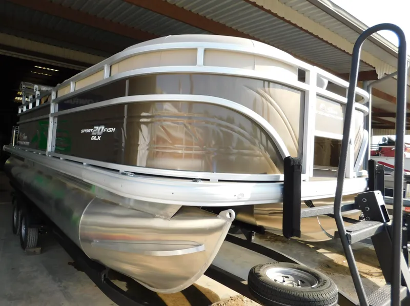 Slide: The Image of 2025 Sun Tracker SportFish 20 DLX pontoon boat on trailer in storage. - 3