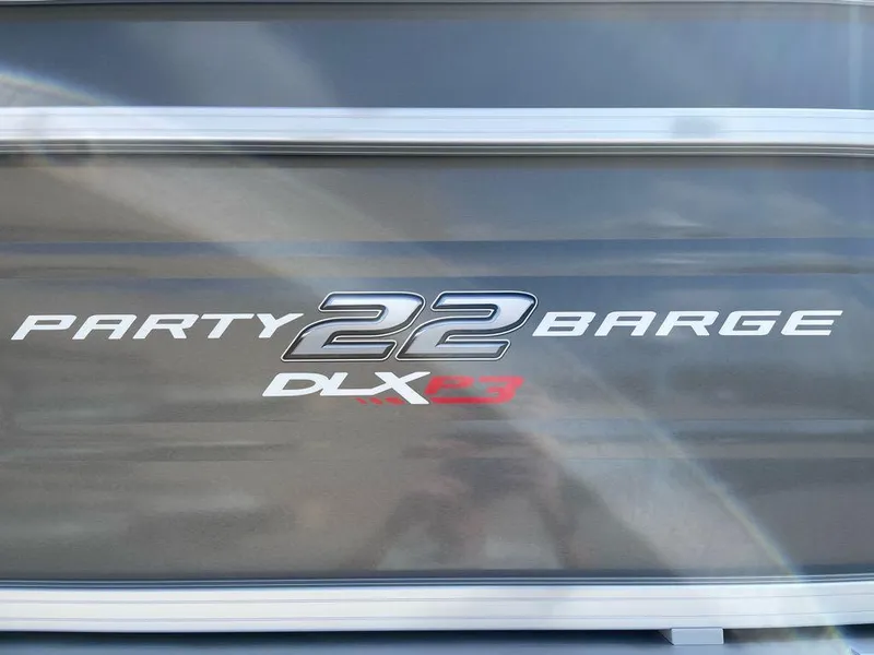 Slide: The Image of Sun Tracker Party Barge 22 RF XP3 2025 logo on boat exterior. - 2
