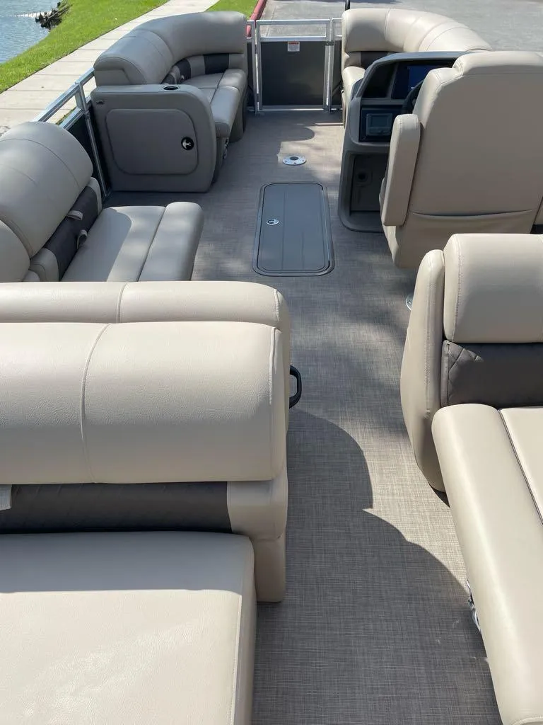 Slide: The Image of 2025 Sun Tracker Party Barge 22 RF XP3 interior with beige seating and spacious layout. - 4
