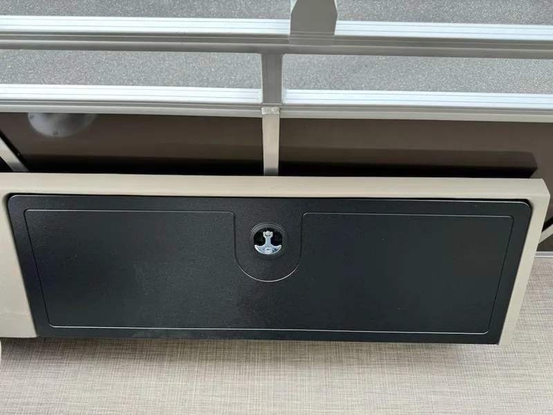 Slide: The Image of 2025 Sun Tracker SportFish 22 XP3 storage compartment with lock, beige and black design. - 10