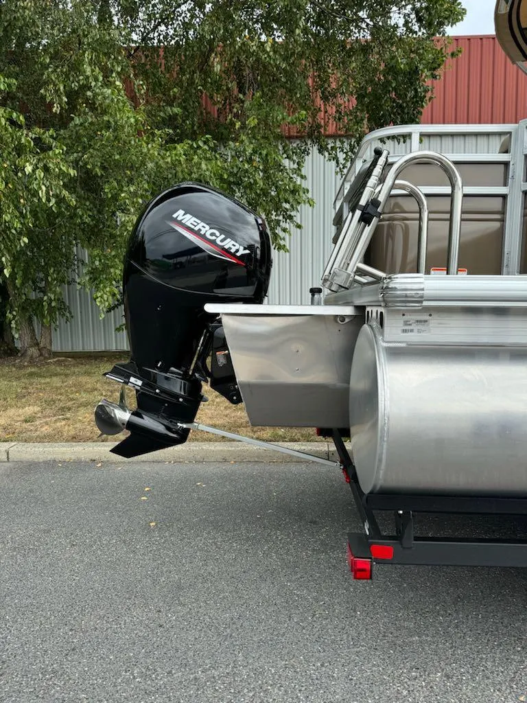 Slide: The Image of 2025 Sun Tracker SportFish 22 XP3 with Mercury outboard motor, parked outdoors. - 4