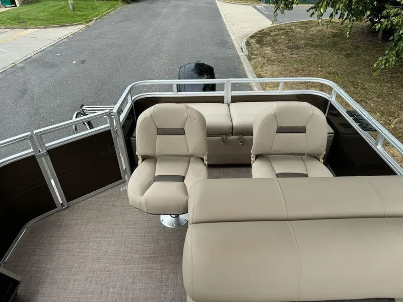 Slide: The Image of 2025 Sun Tracker SportFish 22 XP3 boat interior with beige seating and spacious deck. - 8