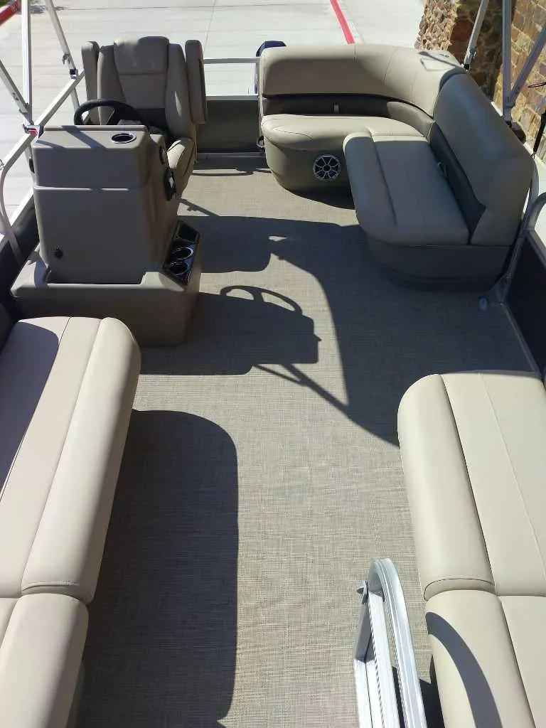 Slide: The Image of 2025 Sun Tracker Party Barge 16 DLX interior with beige seating and spacious layout. - 6
