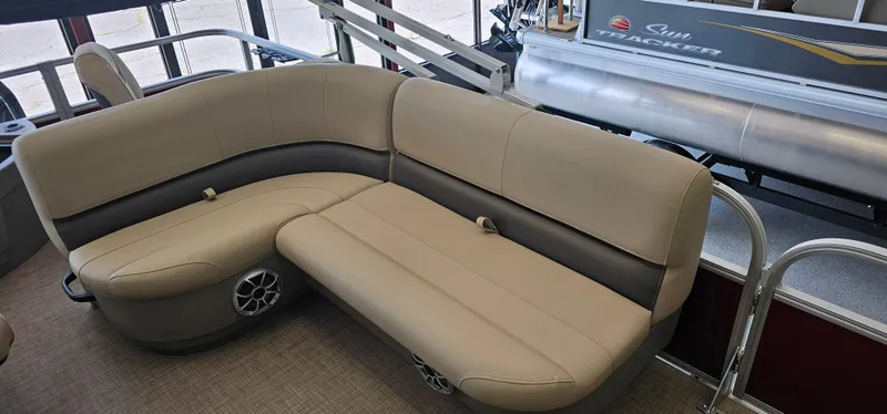 Slide: The Image of 2025 Sun Tracker Bass Buggy 18 DLX pontoon boat interior with beige seating. - 13