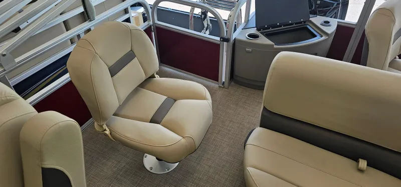 Slide: The Image of 2025 Sun Tracker Bass Buggy 18 DLX interior with beige seating and storage compartments. - 14