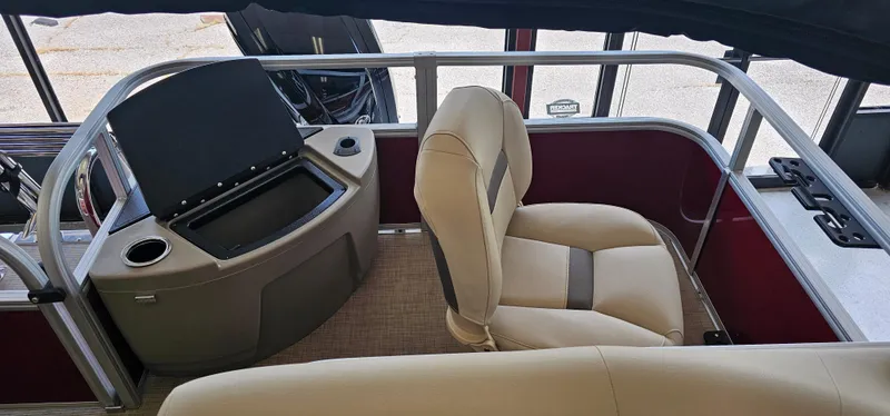 Slide: The Image of 2025 Sun Tracker Bass Buggy 18 DLX interior with beige seating and control console. - 15