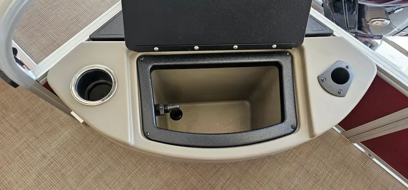 Slide: The Image of 2025 Sun Tracker Bass Buggy 18 DLX boat storage compartment with cup holder and rod holder. - 17