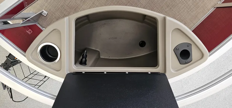 Slide: The Image of 2025 Sun Tracker Bass Buggy 18 DLX boat interior with cup holders and storage compartment. - 4