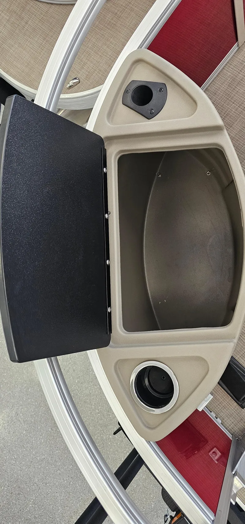 Slide: The Image of 2025 Sun Tracker Bass Buggy 18 DLX storage compartment with cup holders and sleek design. - 6
